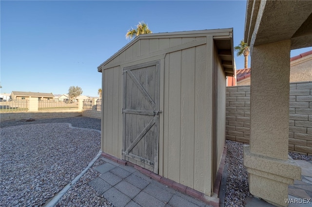 view of shed featuring fence