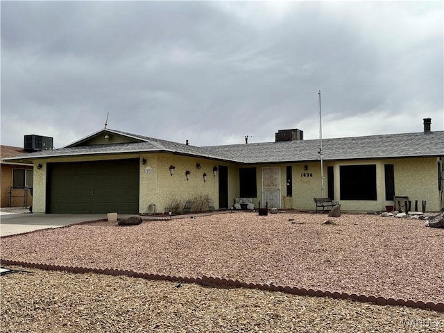 ranch-style home with concrete driveway, an attached garage, cooling unit, and stucco siding