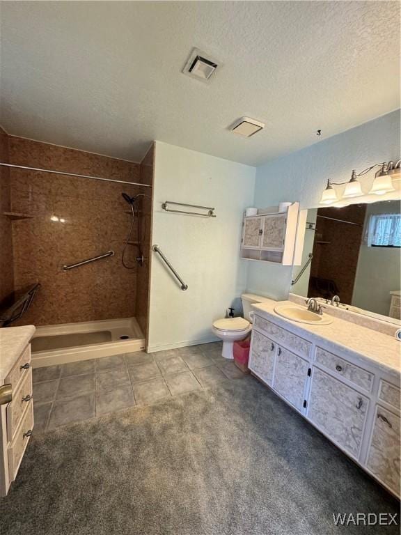 bathroom featuring visible vents, tiled shower, tile patterned flooring, a textured ceiling, and vanity