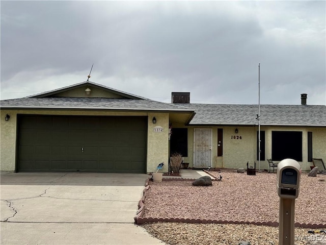 ranch-style home featuring driveway, a shingled roof, an attached garage, and stucco siding