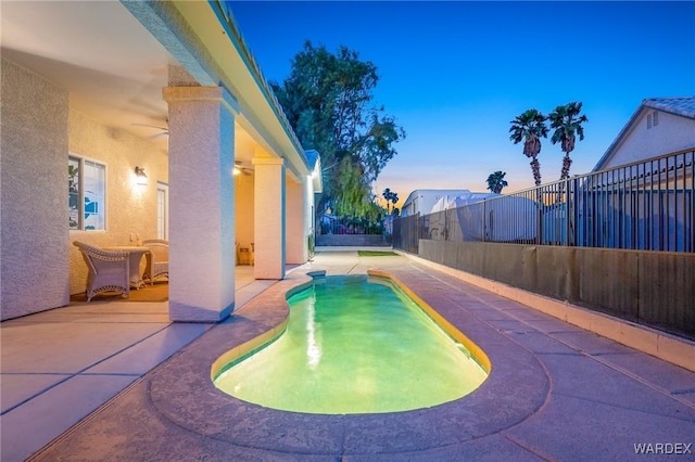 1878 E Clear Lake Dr, Fort Mohave, AZ 86426 - pool at dusk featuring a patio area, a fenced backyard, and a fenced in pool