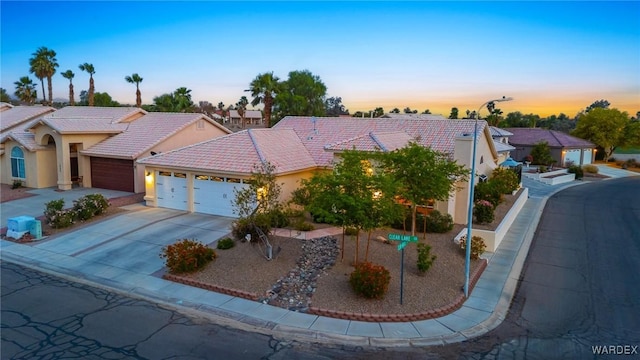 1878 E Clear Lake Dr, Fort Mohave, AZ 86426 - ranch-style house featuring concrete driveway, an attached garage, a tiled roof, and stucco siding