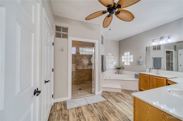 1878 E Clear Lake Dr, Fort Mohave, AZ 86426 - bathroom featuring a garden tub, wood finished floors, visible vents, and a stall shower