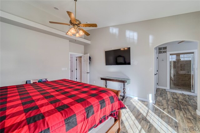1878 E Clear Lake Dr, Fort Mohave, AZ 86426 - bedroom featuring ceiling fan, arched walkways, wood finished floors, and baseboards