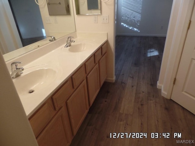 full bath with wood finished floors and a sink