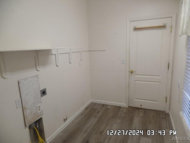 laundry room with baseboards, laundry area, electric dryer hookup, and light wood-style floors