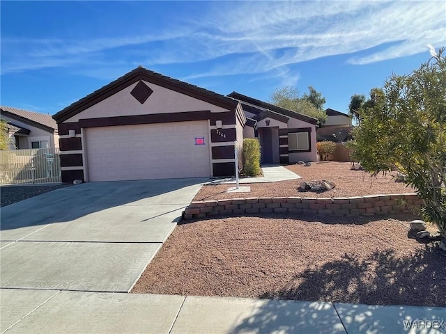 view of front of property featuring driveway, an attached garage, and stucco siding