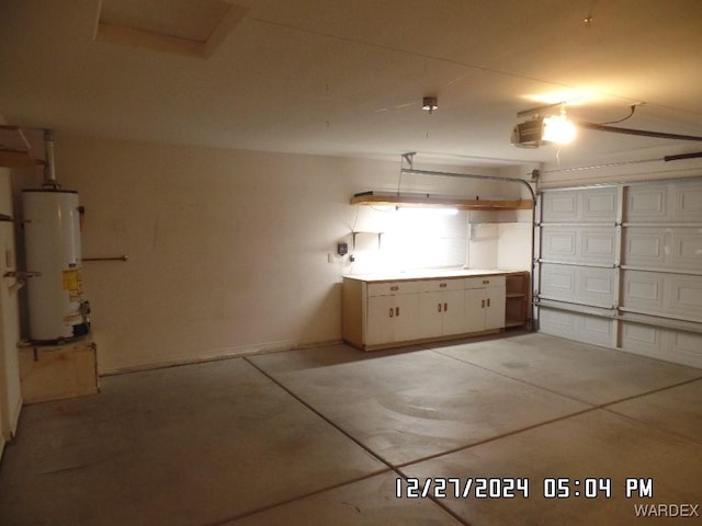 garage featuring a garage door opener and water heater