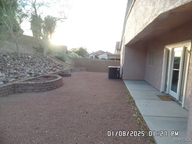 view of yard featuring fence, cooling unit, and a patio