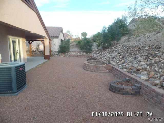 view of yard with cooling unit and a patio area