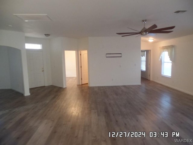 spare room featuring ceiling fan, dark wood-style flooring, visible vents, and baseboards