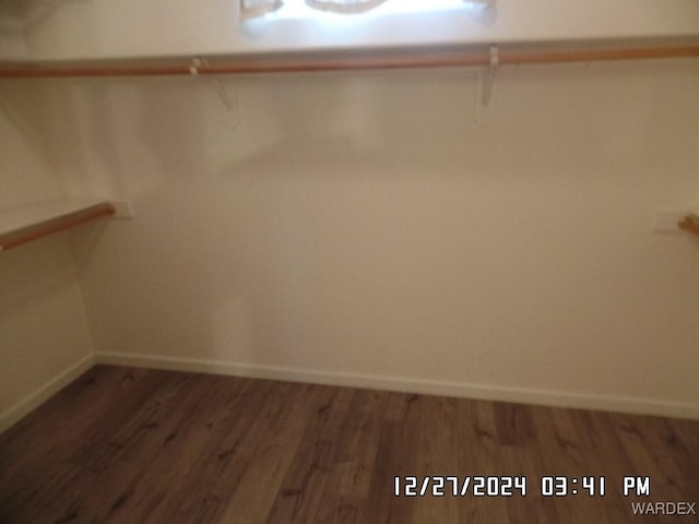 walk in closet featuring dark wood-type flooring