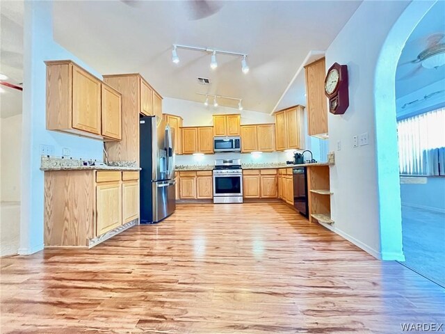 kitchen featuring visible vents, light wood-style flooring, appliances with stainless steel finishes, light brown cabinets, and vaulted ceiling