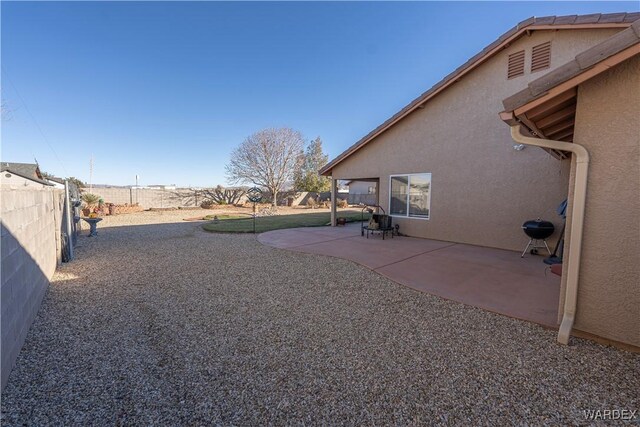 view of yard with a fenced backyard and a patio