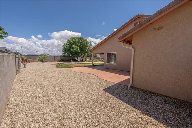 fenced backyard with a patio area