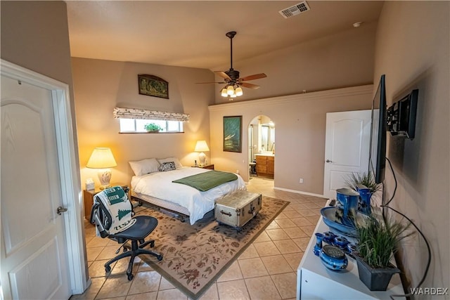 bedroom with high vaulted ceiling, ensuite bath, visible vents, and light tile patterned flooring