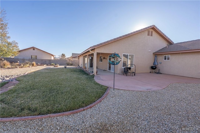 rear view of property with a patio area, a fenced backyard, a lawn, and stucco siding