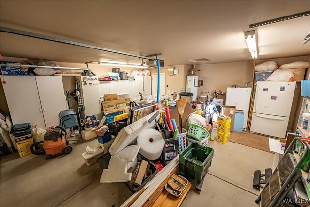 garage with freestanding refrigerator and water heater