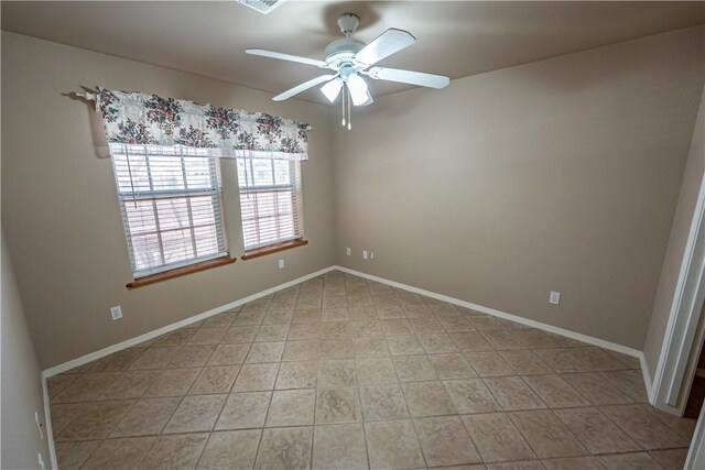 unfurnished room featuring ceiling fan and baseboards