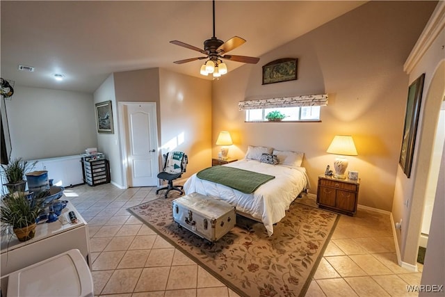 bedroom featuring vaulted ceiling, light tile patterned flooring, visible vents, and baseboards