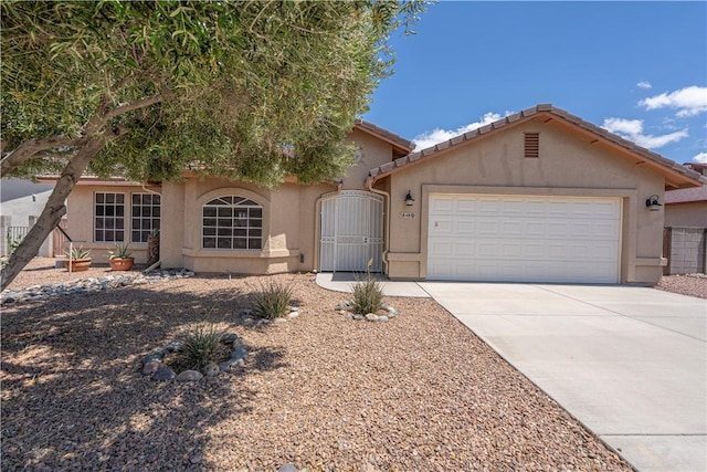 ranch-style home with stucco siding, a garage, and concrete driveway