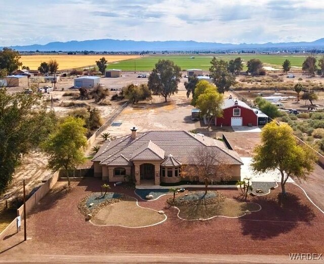 birds eye view of property with a rural view and a mountain view