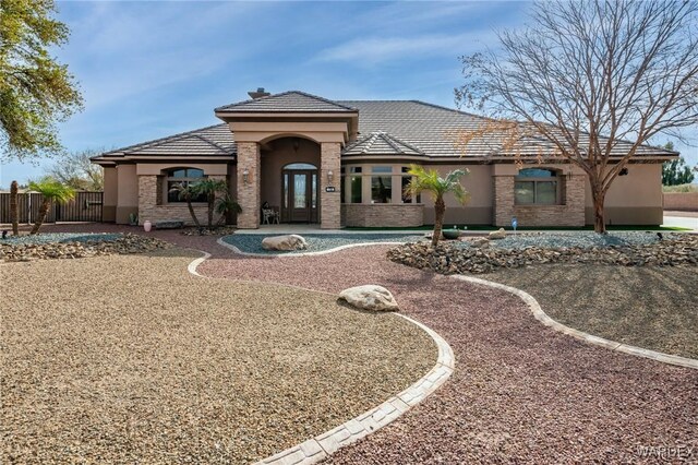 view of front of home with fence and stucco siding