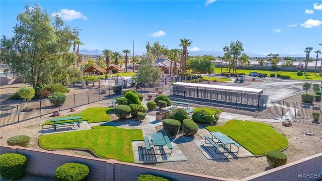 view of property's community with a residential view, fence, a gazebo, and a lawn