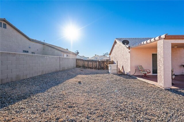 view of yard with a fenced backyard and a patio