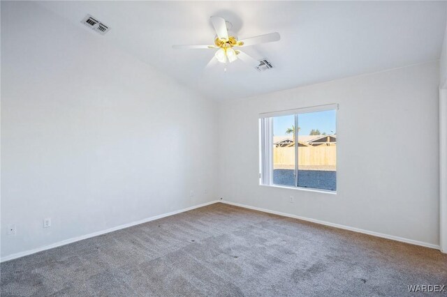 carpeted spare room with ceiling fan, visible vents, and baseboards