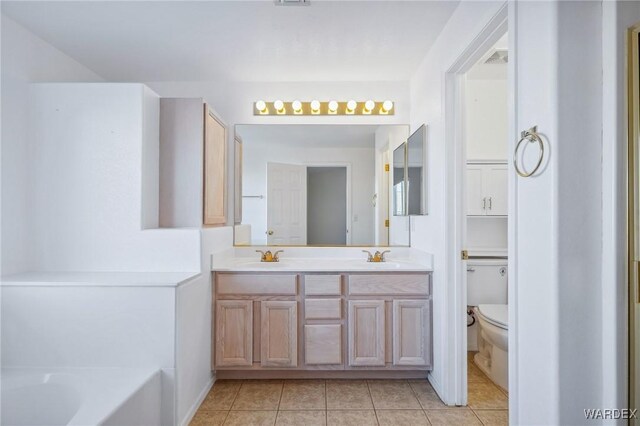 full bathroom featuring double vanity, visible vents, toilet, tile patterned flooring, and a washtub