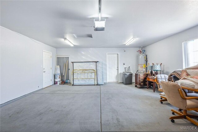 garage with water heater and a garage door opener