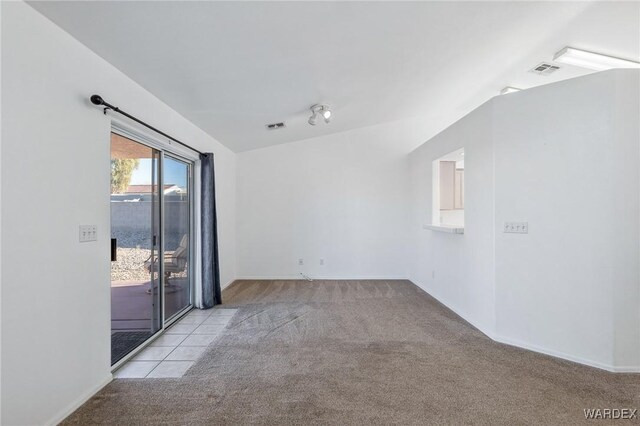 spare room with visible vents and light colored carpet