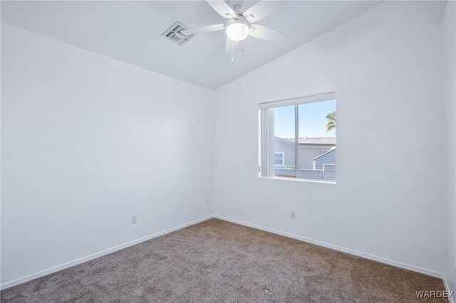 empty room with baseboards, visible vents, a ceiling fan, lofted ceiling, and carpet floors