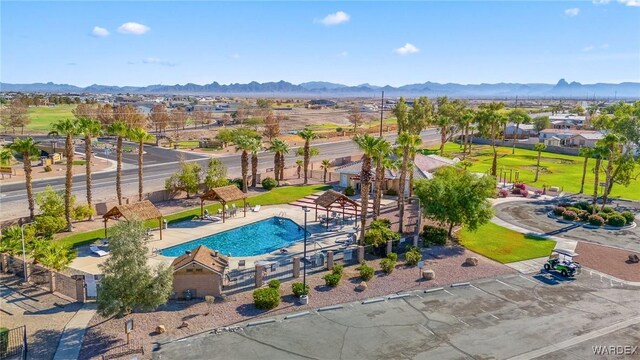 view of swimming pool featuring a mountain view and fence