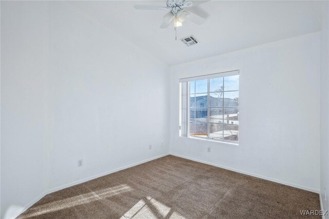 carpeted spare room featuring baseboards, visible vents, and a ceiling fan