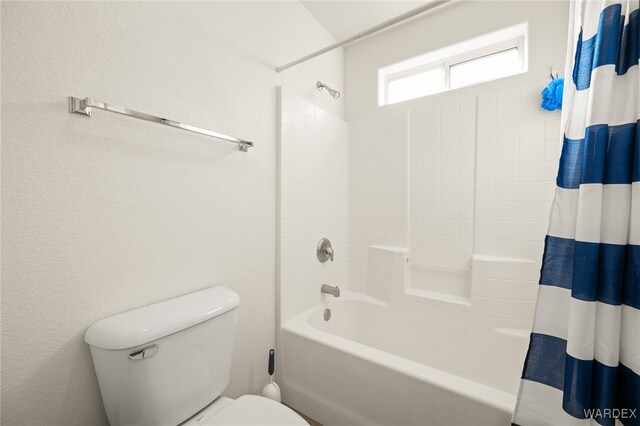 bathroom with toilet and shower / bath combo