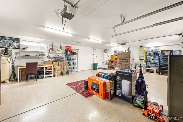 garage featuring water heater, a workshop area, and a garage door opener