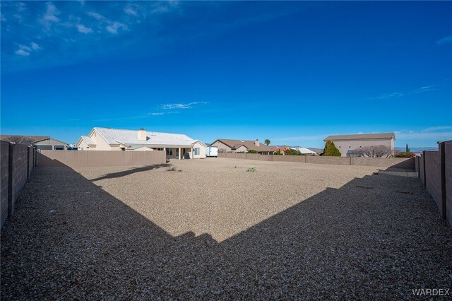 view of yard with a fenced backyard and a residential view