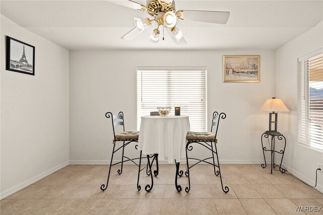 dining room featuring light tile patterned floors, baseboards, and a ceiling fan