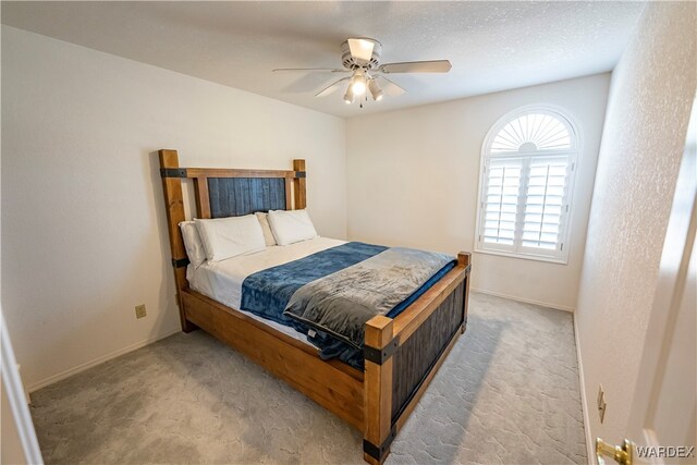 bedroom featuring carpet floors, ceiling fan, a textured ceiling, and baseboards