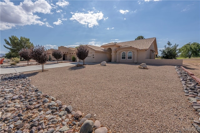 view of front of property featuring a tiled roof and stucco siding