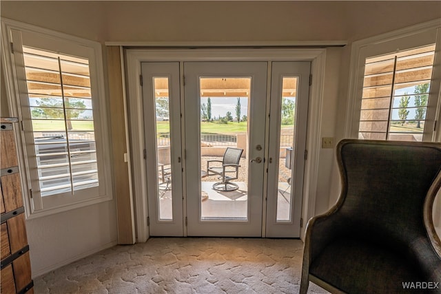 entryway featuring light carpet