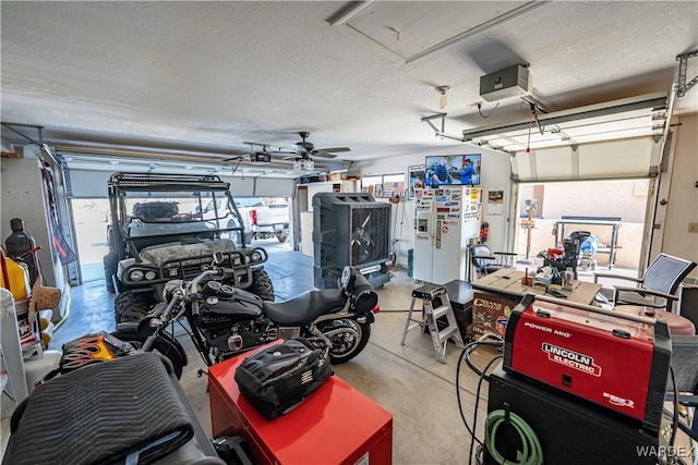 garage featuring a ceiling fan and a garage door opener