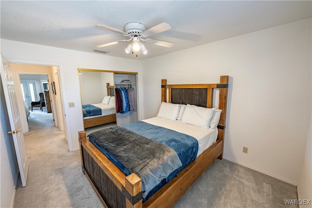 bedroom featuring a ceiling fan, a closet, visible vents, and carpet flooring