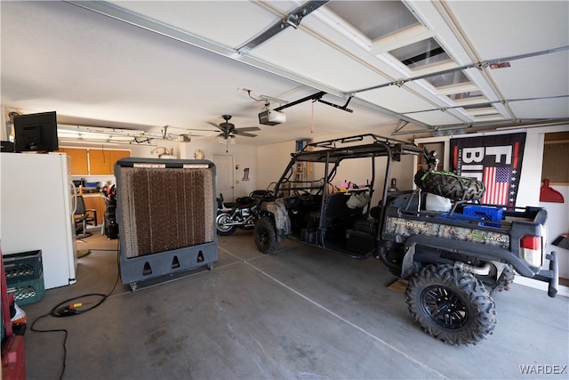 garage with a garage door opener and freestanding refrigerator