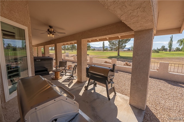 view of patio / terrace with a fenced backyard, a grill, and a ceiling fan