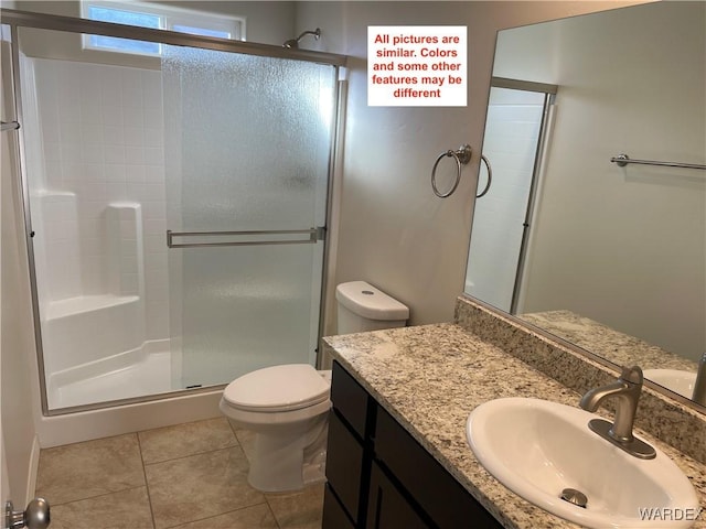 full bathroom featuring a stall shower, tile patterned flooring, vanity, and toilet