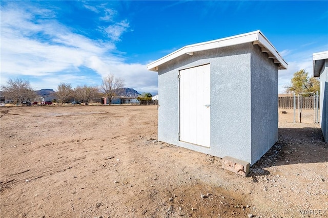 view of shed featuring fence