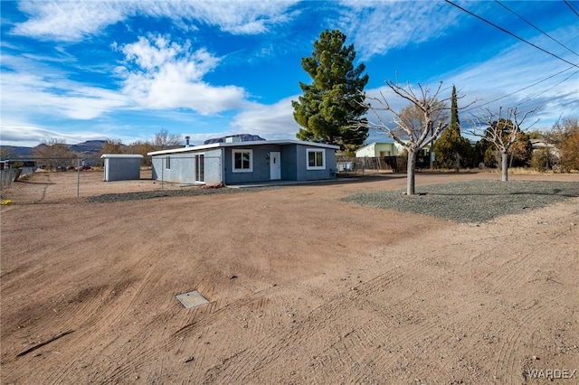 view of front of house with fence and a mountain view